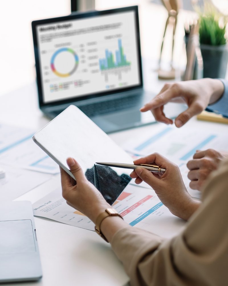 Reviewing business charts on a laptop